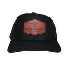 BCN Classic Trucker Curved Hat in solid black with hexagonal cognac leather patch sewn onto the front panel — front view
