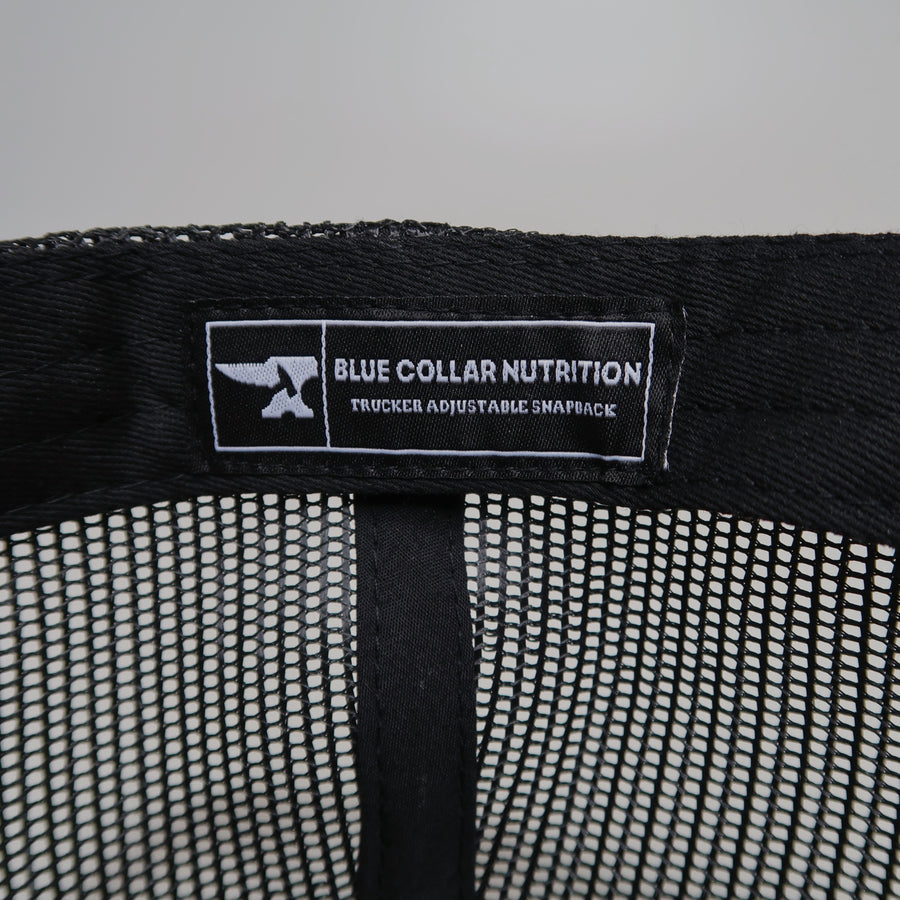 Interior tag of the BCN Classic Trucker Hat reading Blue Collar Nutrition Trucker Adjustable Snapback