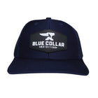 BCN Classic Trucker Curved Hat in navy blue with hexagonal 3D PVC patch — raised white logo, front view of pvc patch trucker hat