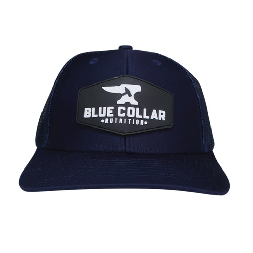 BCN Classic Trucker Curved Hat in navy blue with hexagonal 3D PVC patch — raised white logo, front view of pvc patch trucker hat